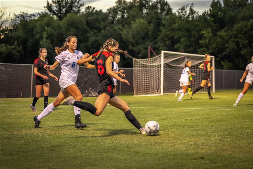 Soccer players dribble the ball